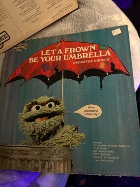 Sesame Street Oscar the Grouch Red Umbrella Blue Background Kids Book Cover